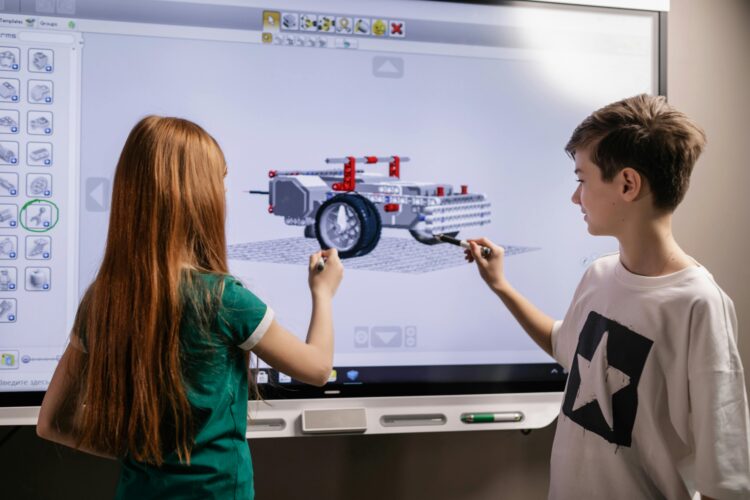 to børn foran en storskærm med en robot på