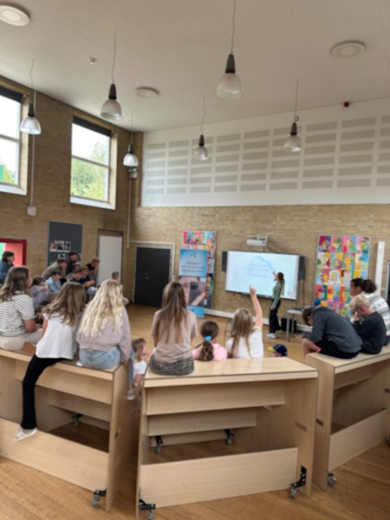 Carousel image showing a presentation for school classes.